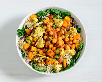 Chicken curry bowl from Veggie Grill in white bowl on white table