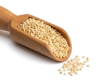 Wooden scoop of quinoa seeds